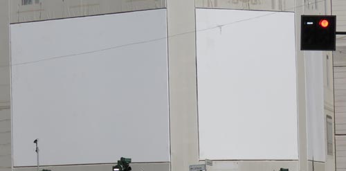 Londre Marketing Global Advertisers Wanted 2022: Two blank billboards on side of building
